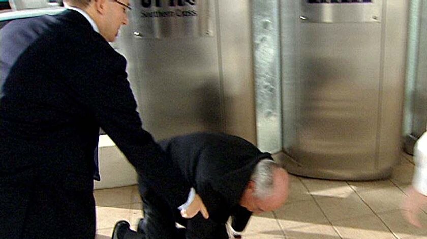 John Howard took a tumble while heading to a radio interview in Perth.