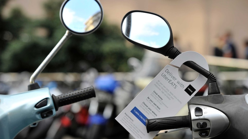 An advertisement seeking drivers for UberEATS seen on a motorbike in Sydney.