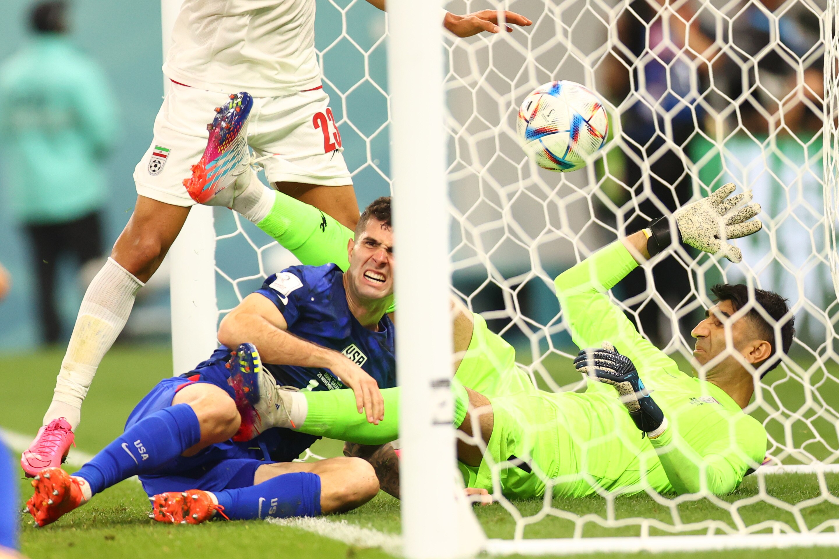 Christian Pulisic looks to be in pain as he lays next to Iran's goalkeeper on the goal line