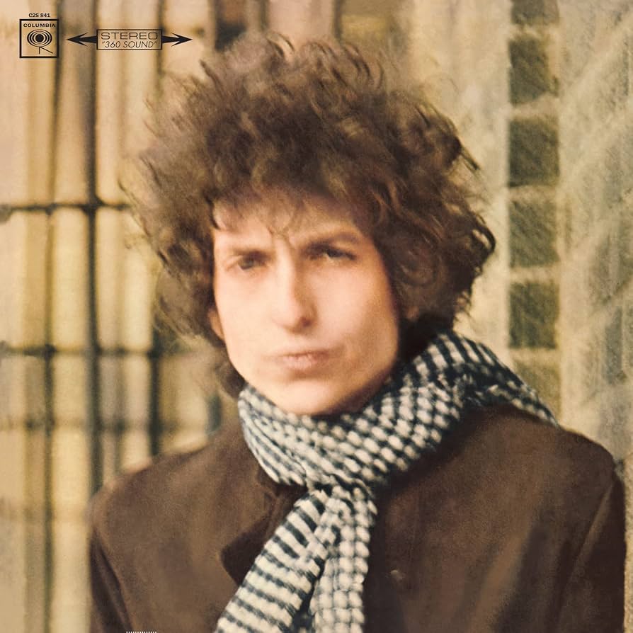 Front cover of Blonde on Blonde is a blurry headshot of Bob Dylan with wild hair wearing a scarf and warm jacket