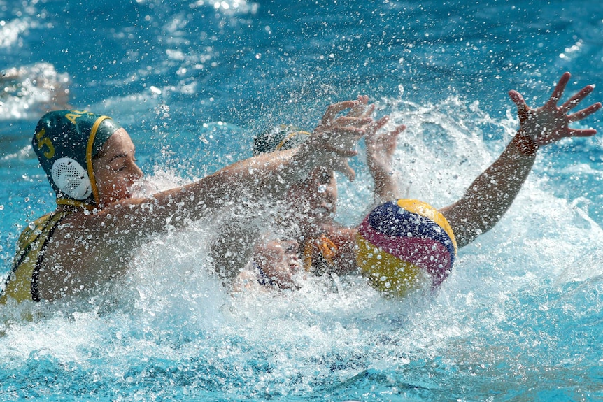 Australia's Keesja Gofers and Russia's Anna Grineva battle for ball in Olympic women's water polo.