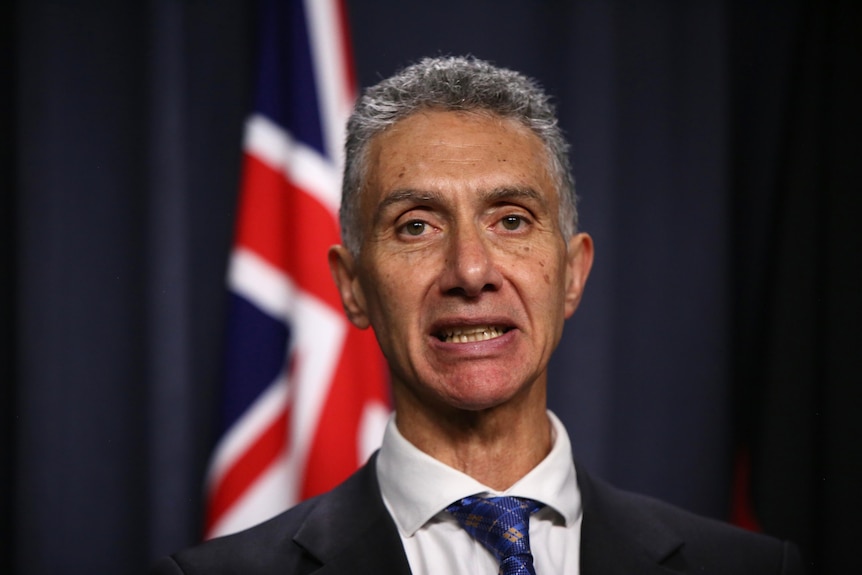 Headshot of Tony Buti standing at a podium