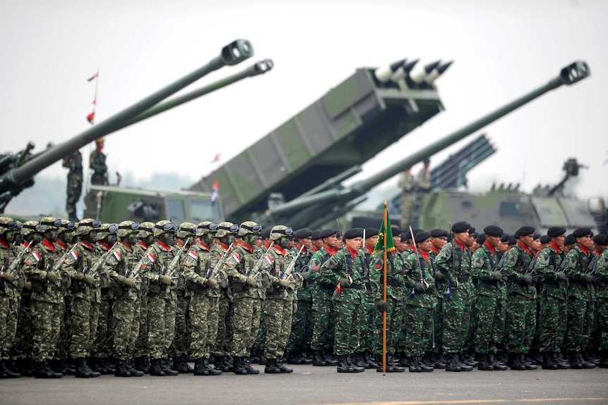 Indonesian military troops stand in formation.