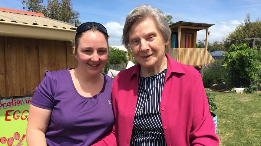 Francie Korotki stands with a carer in the community garden at Dodges Ferry