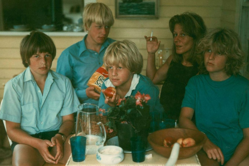 An old photograph of three blonde boys and a blonde girl with a woman
