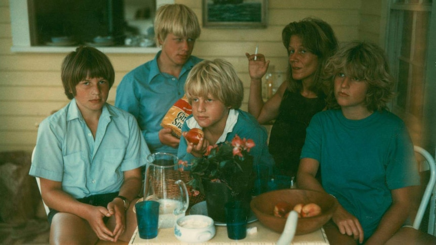 An old photograph of three blonde boys and a blonde girl with a woman