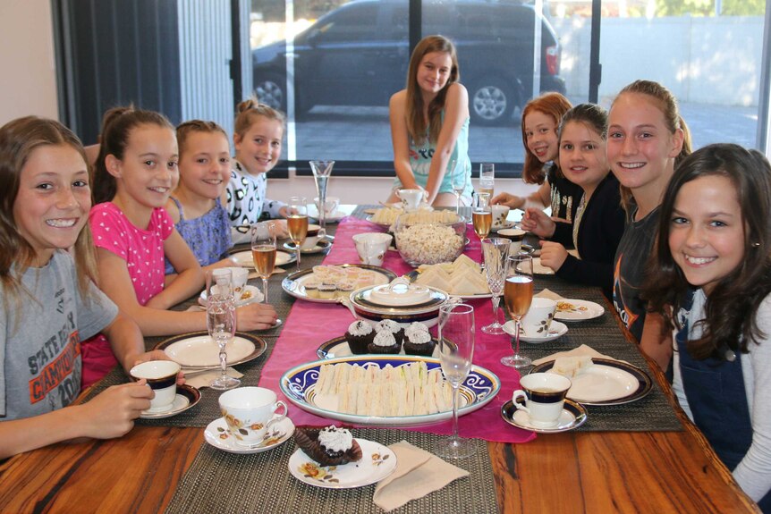 Girls sitting at a table having high tea