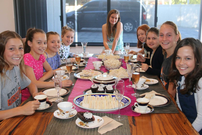 Girls sitting at a table having high tea