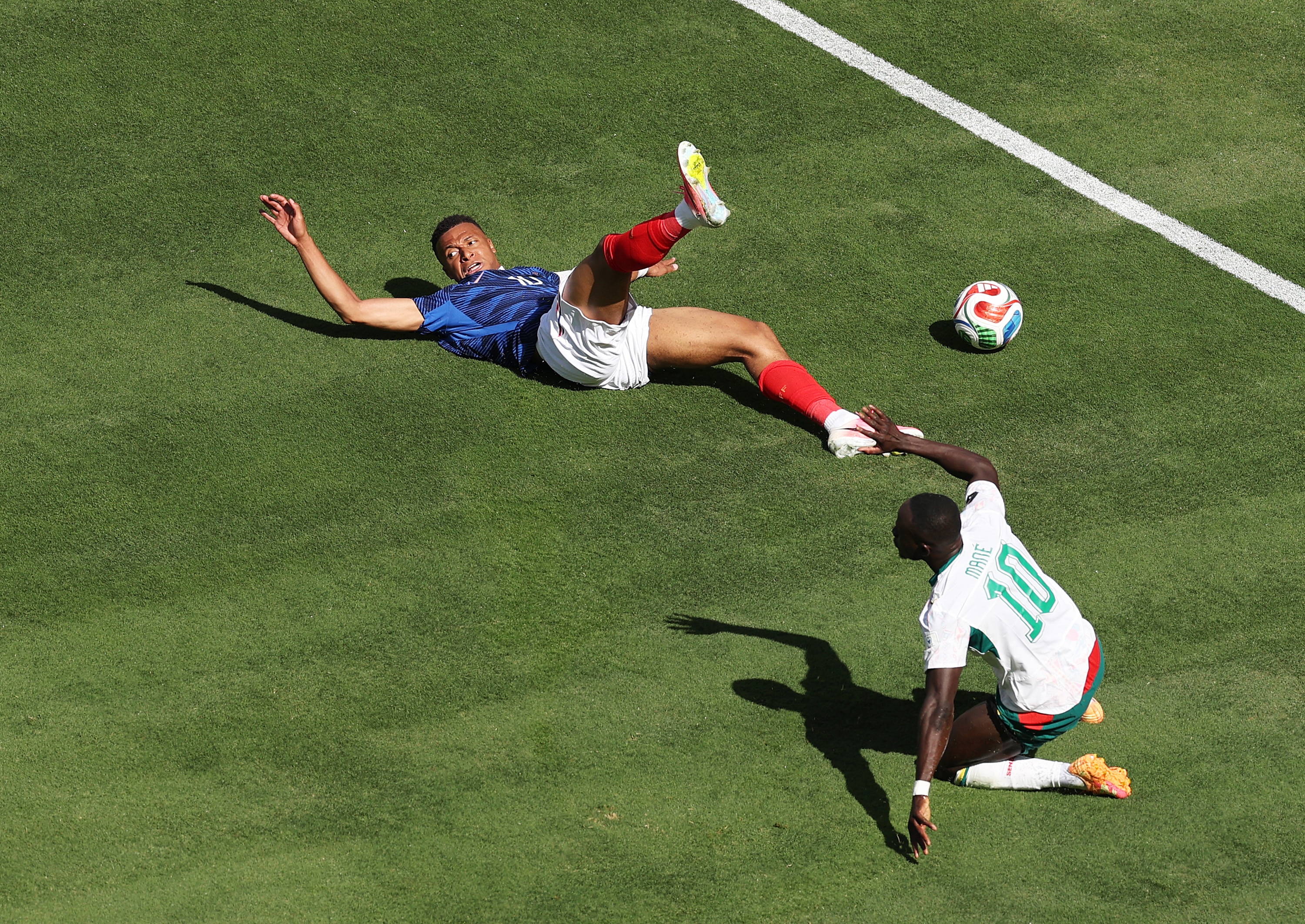 Kylian Mbappé looks back at the referee.