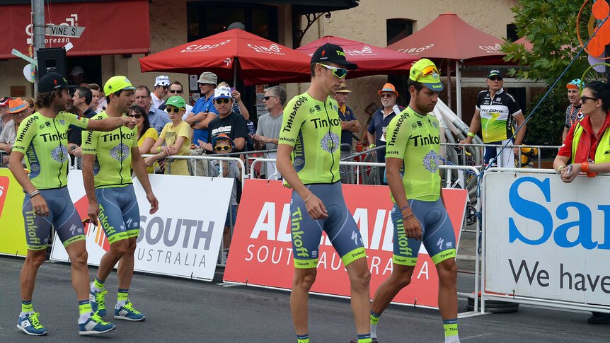 Four members of the Tinkoff team, in their yellow colours, before the start of the race.