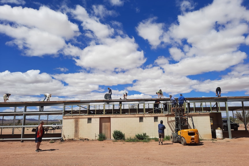 Volunteers working on the steel frame of the new storage facility. 