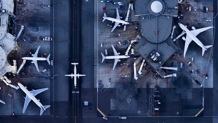 Aerial photograph of planes parked at airport gates.
