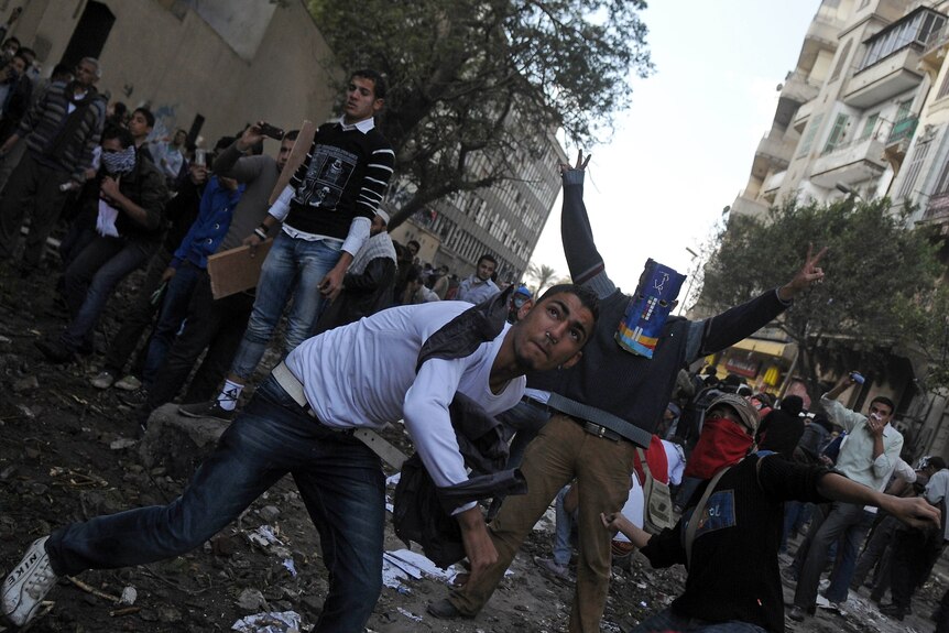 Third day of clashes: Egyptian protesters hurl stones at security forces.