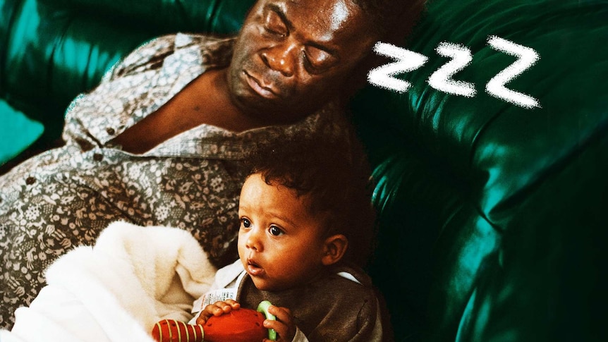 Man sleeping beside awake child