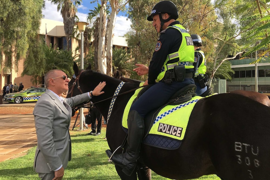 Jay Weatherill talks to a mounted policeman in Alice Springs