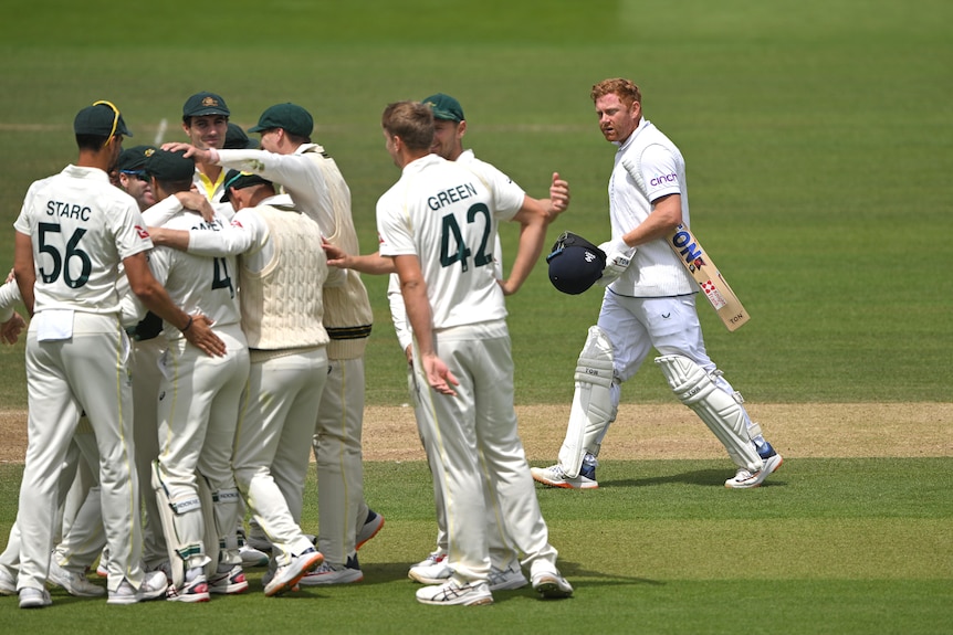 Jonny Bairstow looks in the direction of Australian players celebrating as he walks off the field