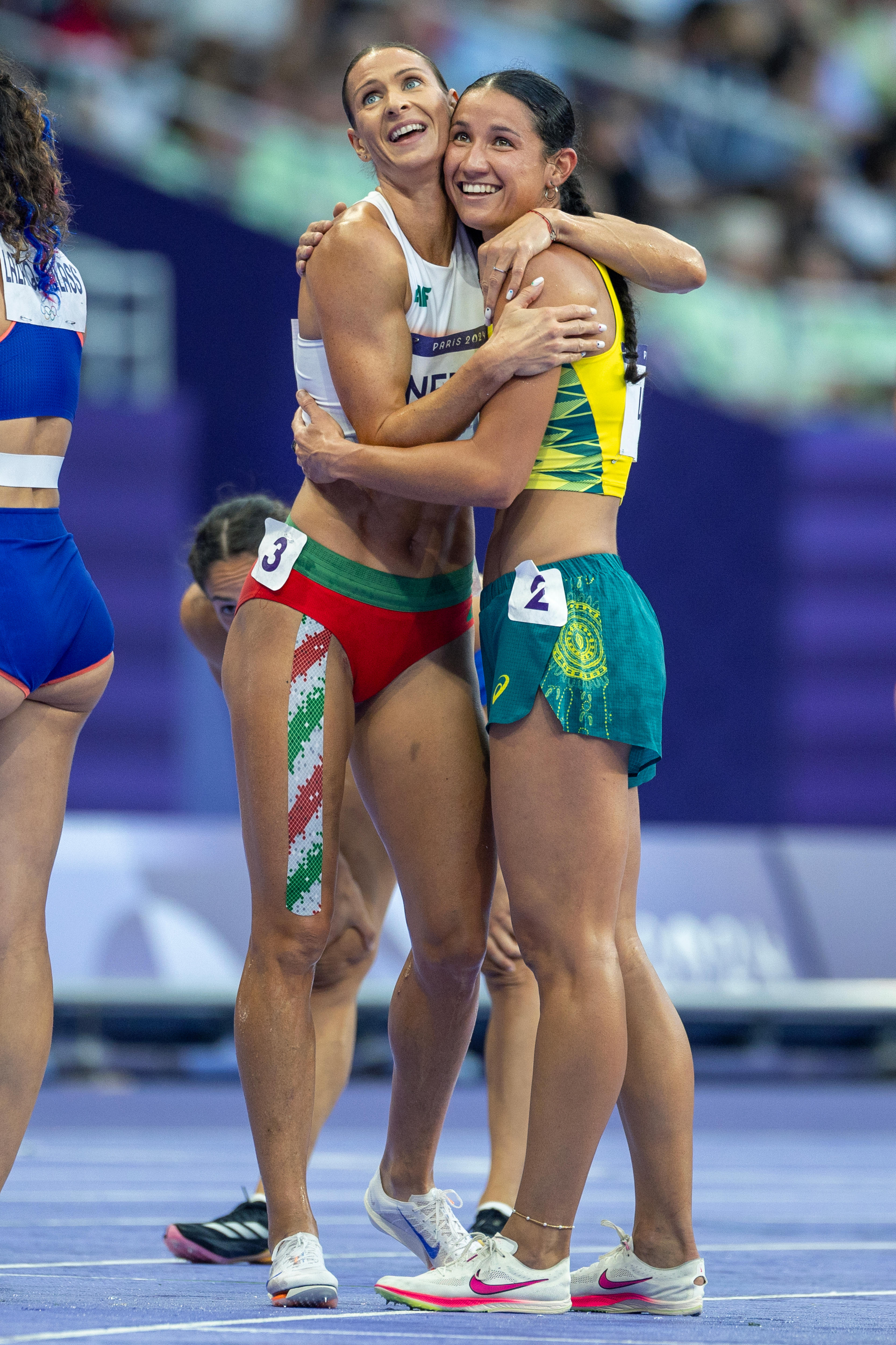 Heptathletes Rita Nemes and Tori West hug at the 2024 Paris Olympics.