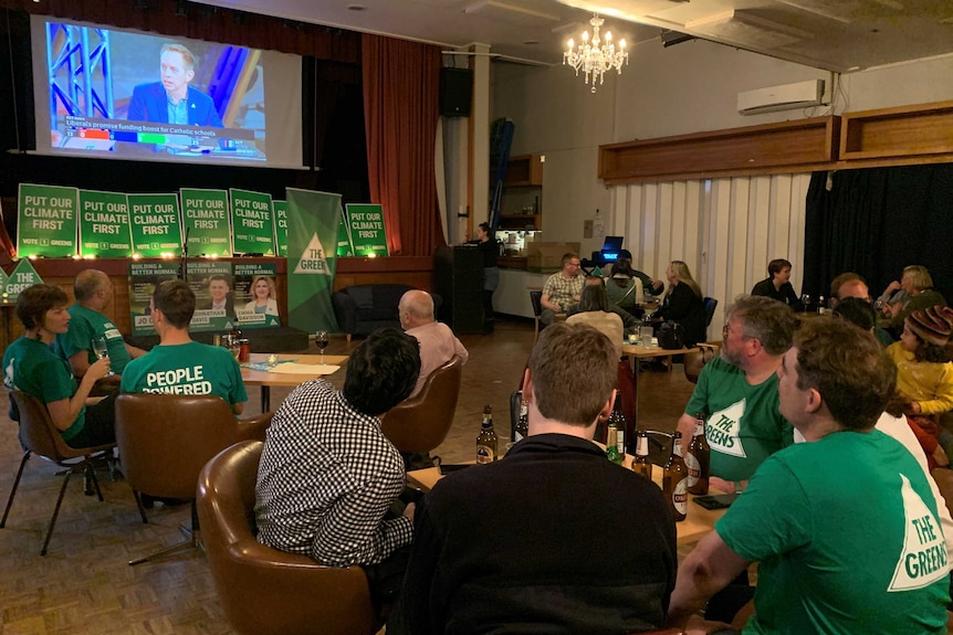 Greens party volunteers watch the ABC's election night broadcast.