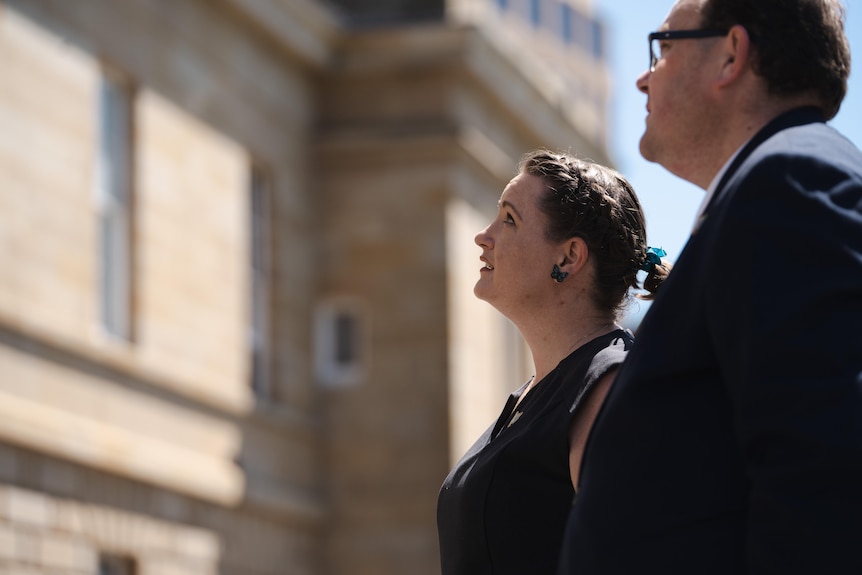 A man and a woman looking up.