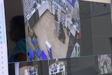 A computer screen showing a live feed of four CCTV cameras in a supermarket.