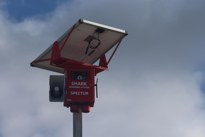 A siren is pictured against a blue sky