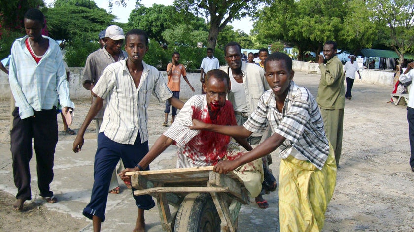 Somali civilians push a wounded man