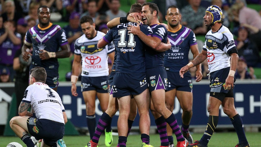 Joe Stimson of the Storm celebrates his try with Cameron Smith against the Cowboys.