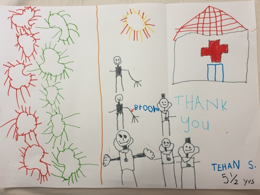 A child's drawing of virus particles and people standing outside a building with a red cross on it.