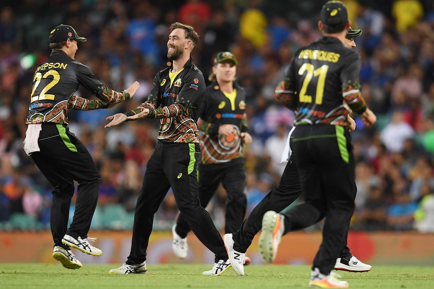 Glenn Maxwell of Australia celebrates taking the wicket of K L Rahul.