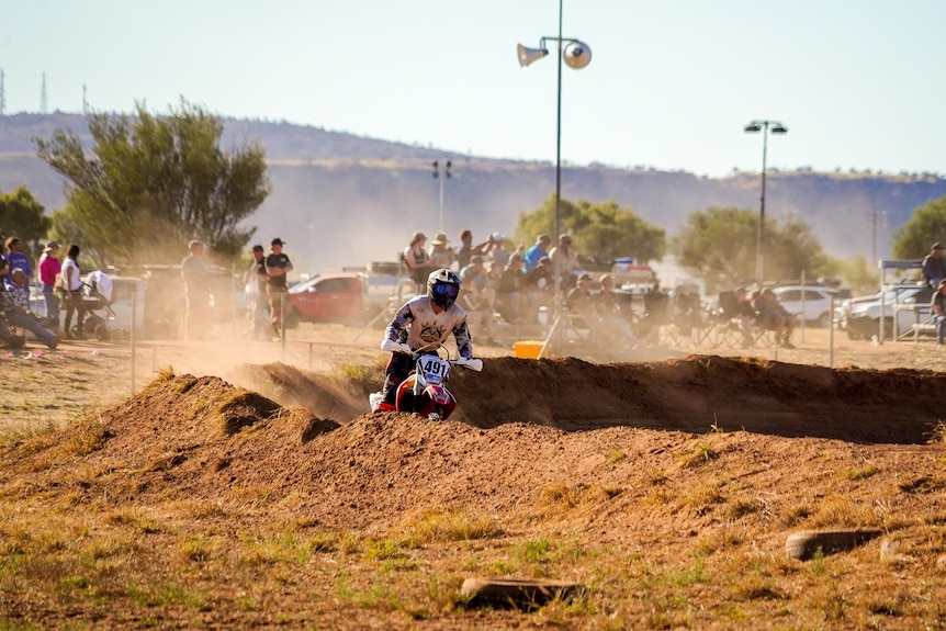 A dirt bike rider navigates through a tough-looking track.