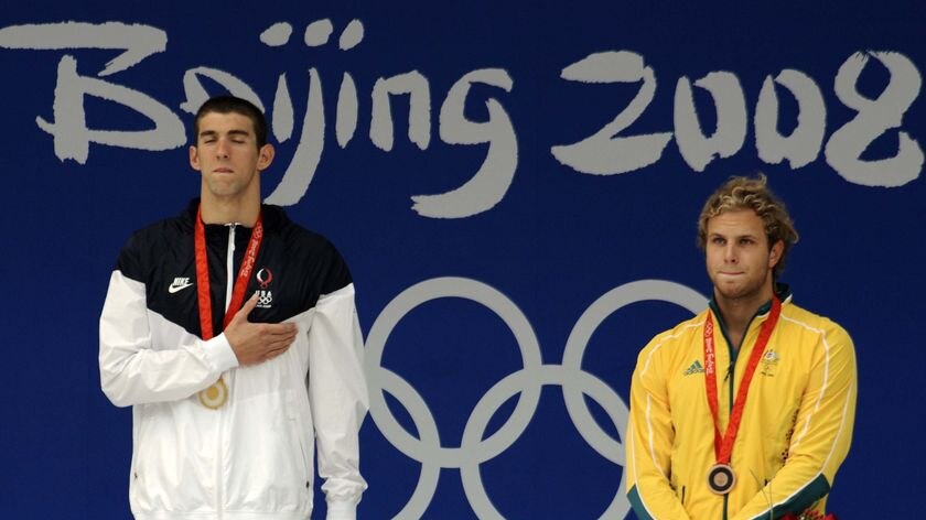 Australia's Andrew Lauterstein receives his bronze medal alongside Michael Phelps.