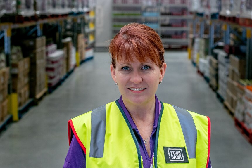 Foodbank WA CEO Kate O'Hara in a warehouse. 