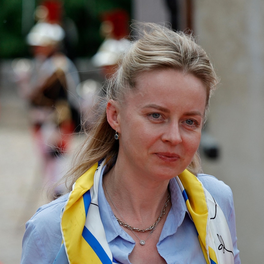 a woman wearing a yellow and white scarf
