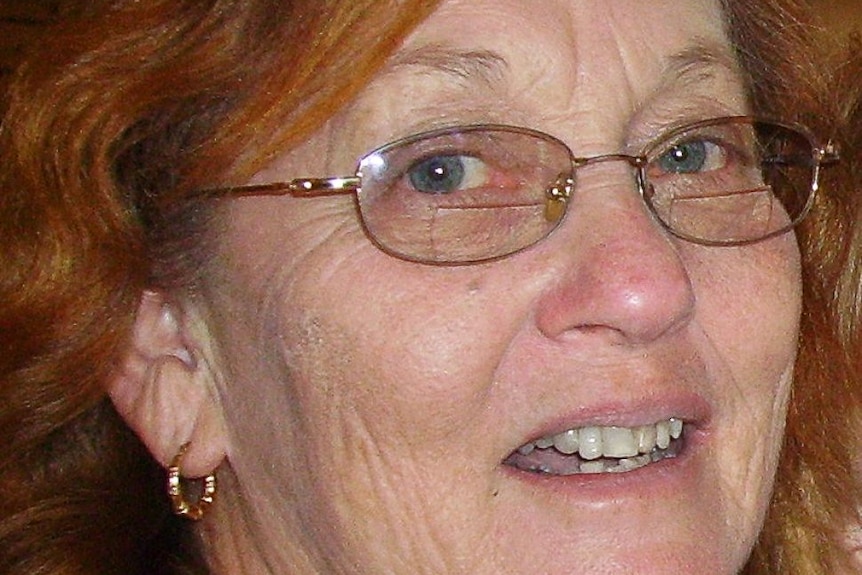 Closeup of a woman with glasses and red hair