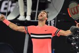 Grigor Dimitrov with his arms spreads as he screams out in celebration after beating Mackenzie McDonald at the Australian Open.