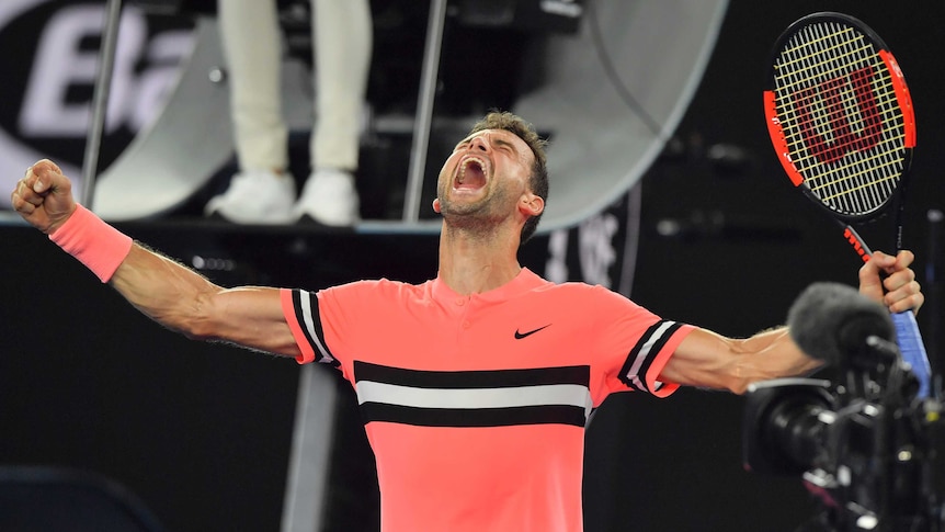 Grigor Dimitrov with his arms spreads as he screams out in celebration after beating Mackenzie McDonald at the Australian Open.