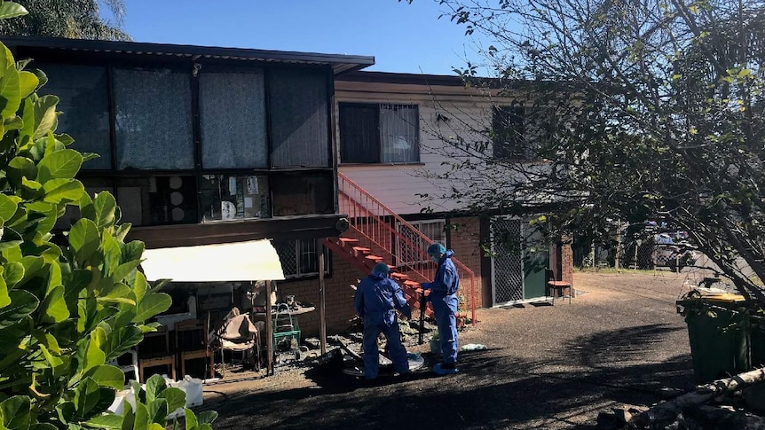 Forensic officers outside the two-storey Logan house where the elderly woman died.