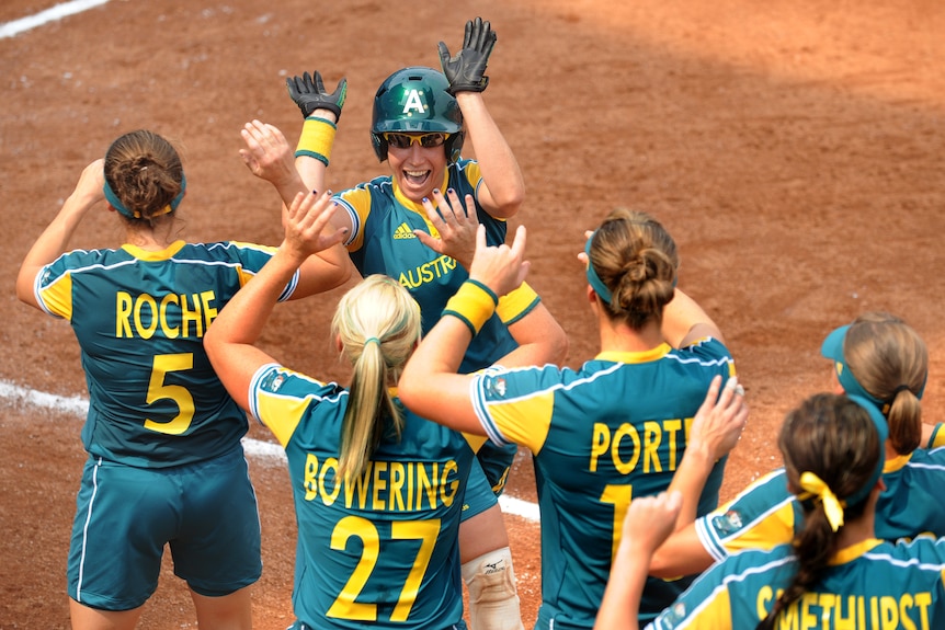 Danielle Stewart celebrates with Australian softball teammates during the 2008 Olympic semi-final match against Canada