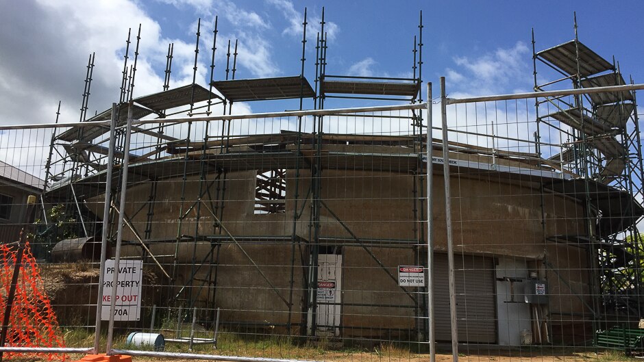 A tank being converted into a house with scaffolding around it