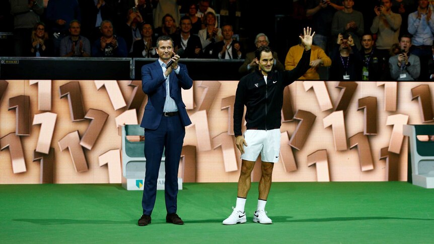 Roger Federer and Tournament Director Richard Krajicek wave at crowd at 2018 Rotterdam Open.