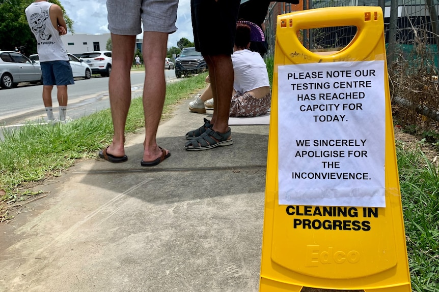 People wait in line for a COVID test