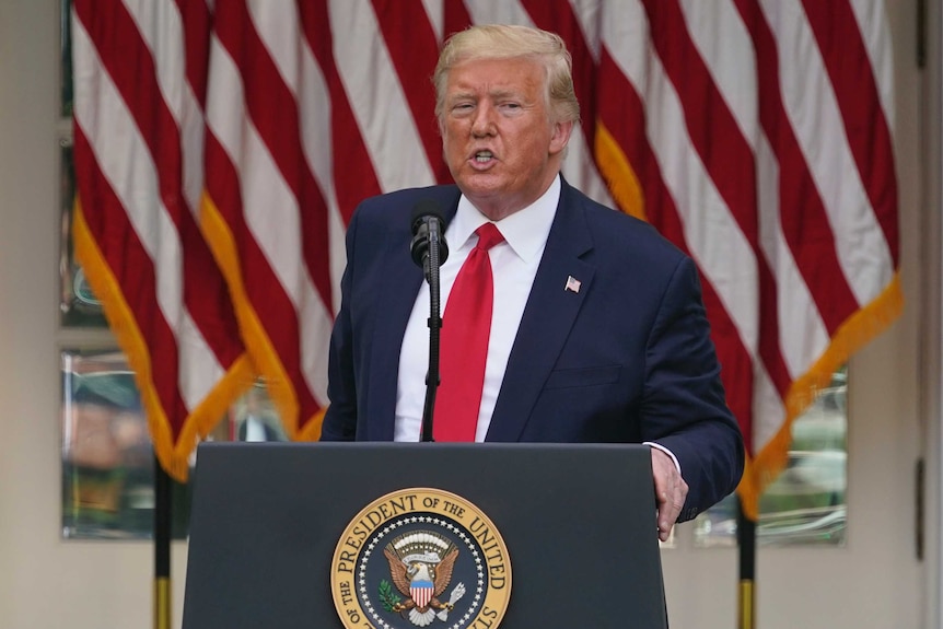 President Donald Trump answers questions from reporters.