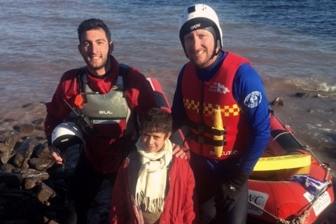 Simon Lewis and another volunteer with a young refugee boy