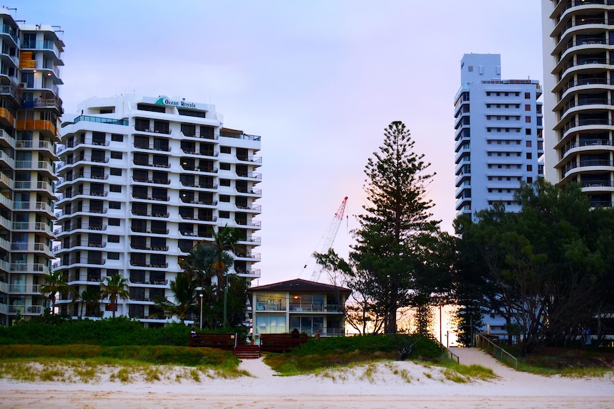 two-storey house surrounding by multi-storey towers