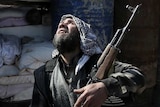 Syrian rebel fighter looks at sky