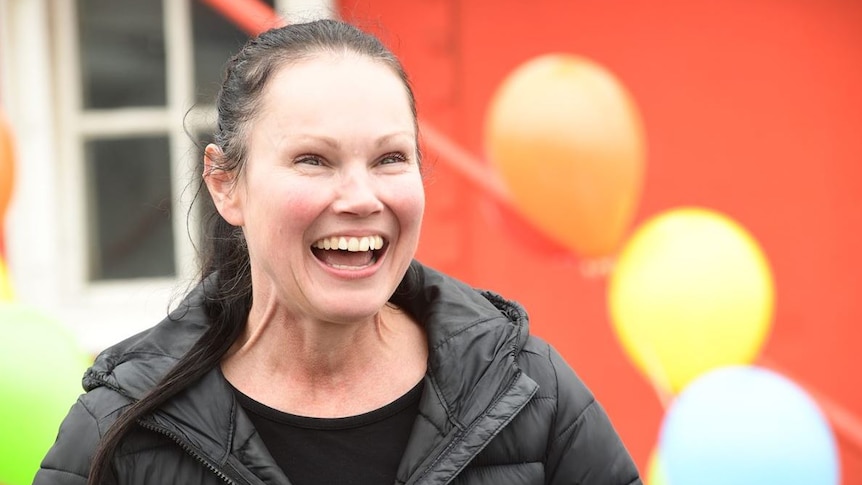 Lee-Anne Lupton smiling with balloons behind her