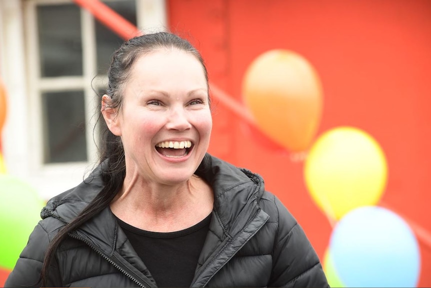 Lee-Anne Lupton smiling with balloons behind her
