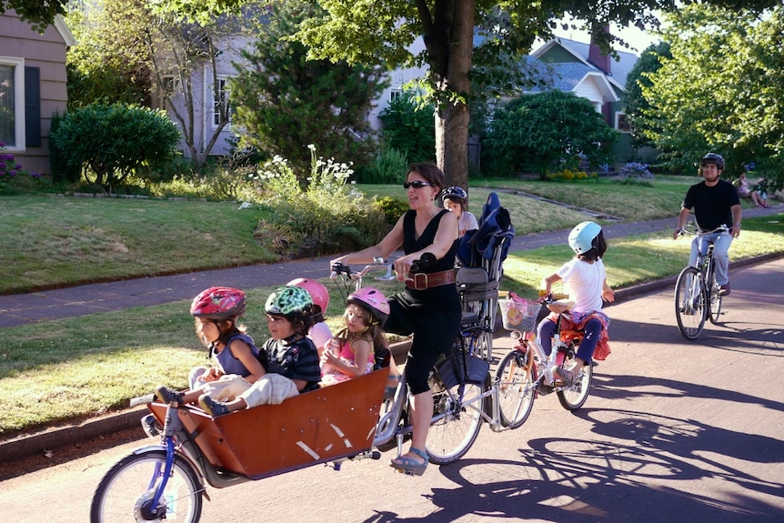A woman and children out for a bike ride in Portland.