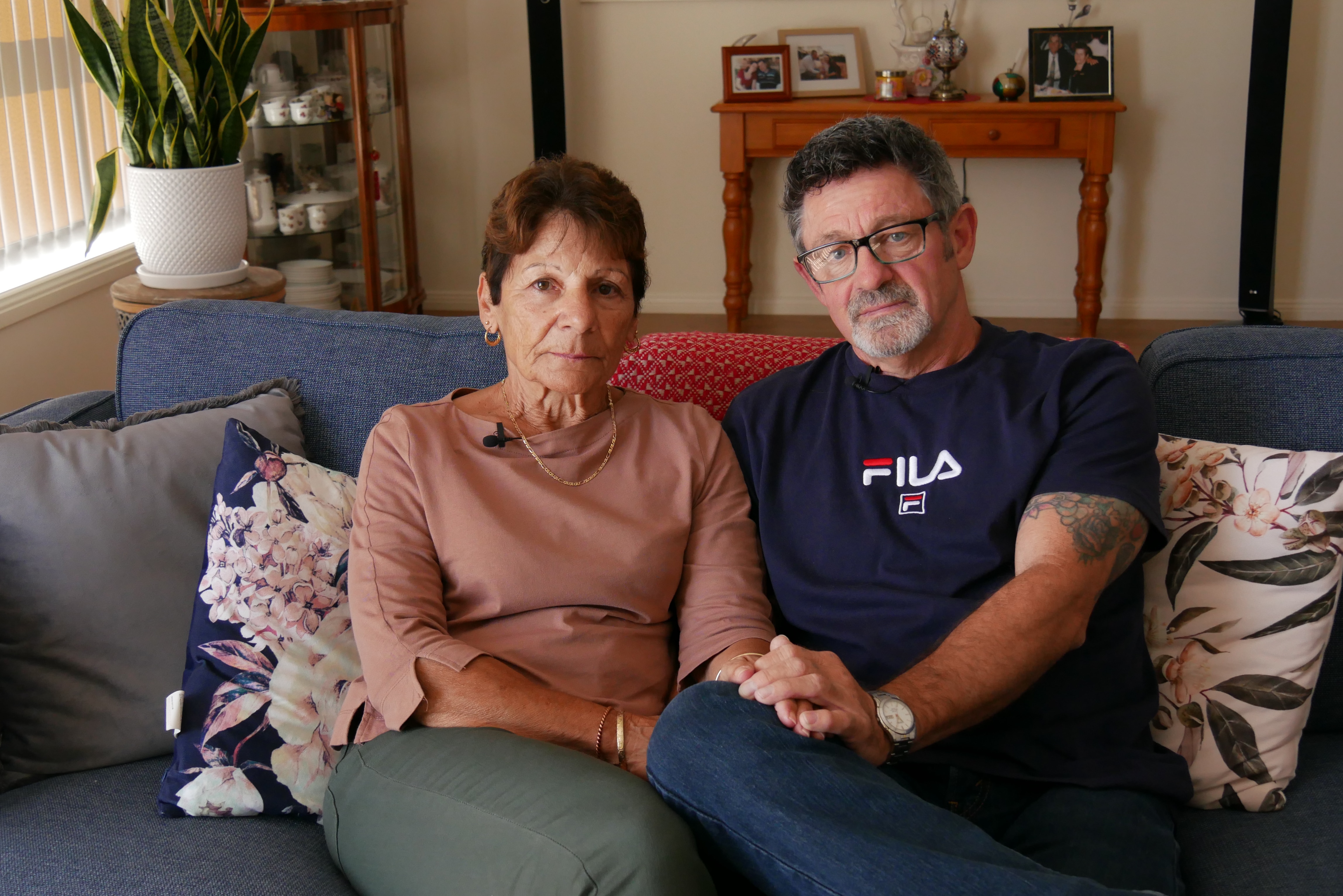 Stella and Jeff sitting on a blue couch 