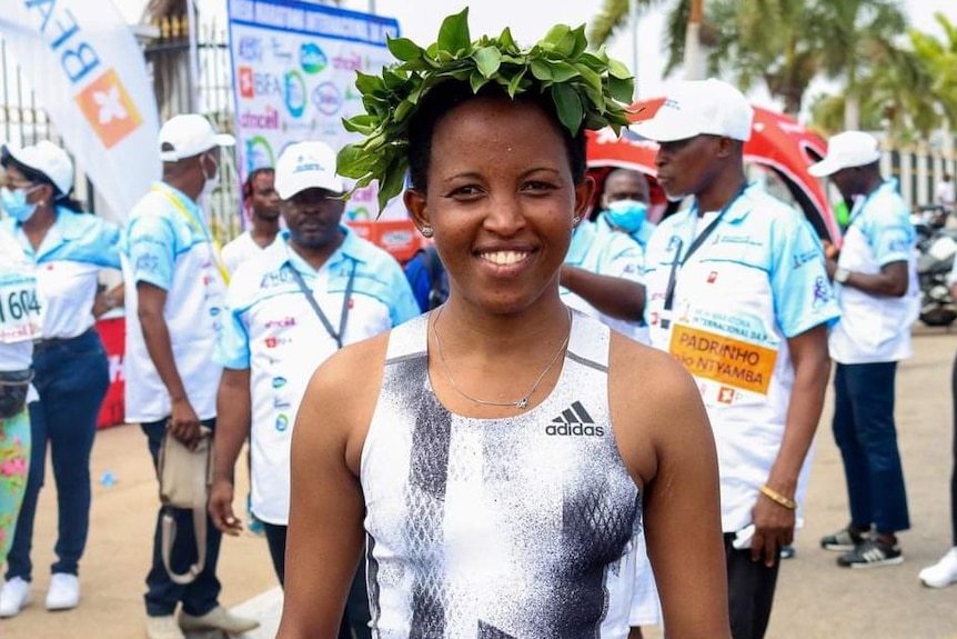 Kenyan-born Bahraini athlete Damaris Muthee Mutua smiles for the camera while wearing a crown of leaves.